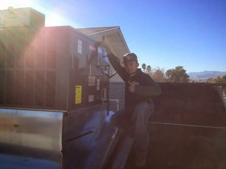 HVAC technician performing AC Tune-Up on a rooftop unit in Azalea Park